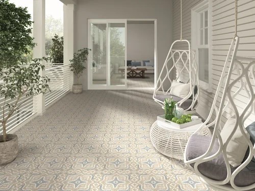 Outdoor balcony space styled with hanging chairs and greenery, featuring Mikron Sirakusa patterned tiles in a star-shaped mosaic design.
